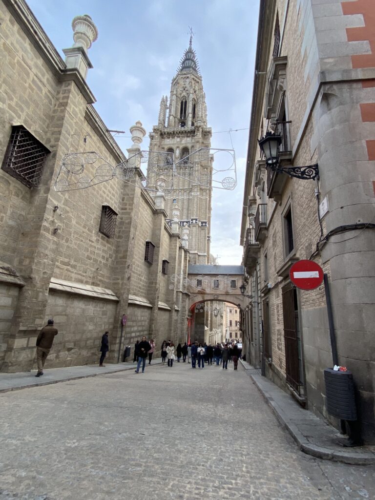 Toledo cathedral with the Christmas lighting and people in the background